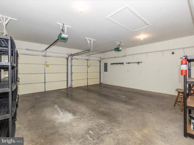 garage with electric panel and a garage door opener