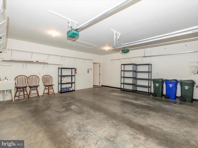 garage featuring a sink and a garage door opener