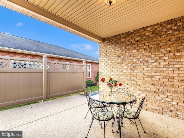 view of patio with fence and outdoor dining area