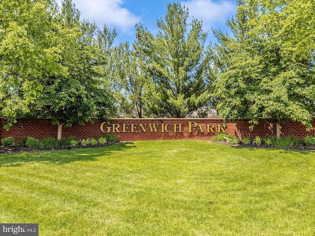 community / neighborhood sign with a yard