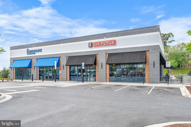 view of commercial property with uncovered parking