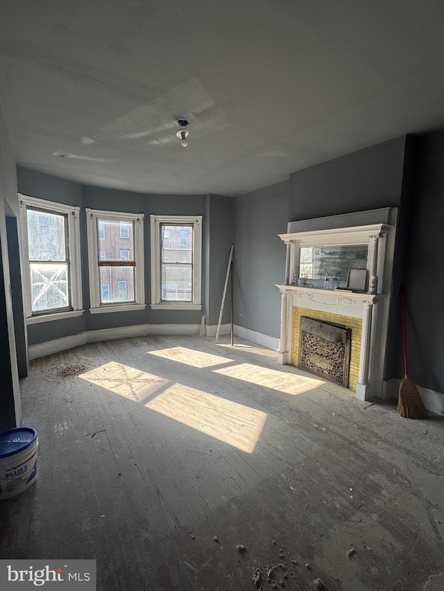 2555 N 33rd St, Philadelphia, PA 19132 - unfurnished living room with a fireplace with flush hearth, plenty of natural light, baseboards, and hardwood / wood-style floors