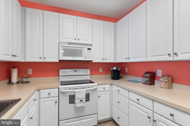 kitchen featuring white appliances and white cabinetry