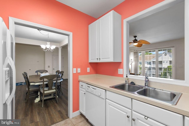 kitchen with white cabinets, white dishwasher, a sink, light countertops, and refrigerator with ice dispenser