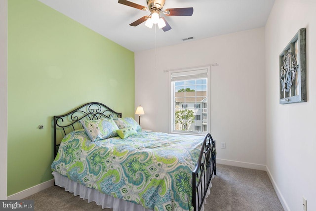 carpeted bedroom featuring baseboards, visible vents, and ceiling fan
