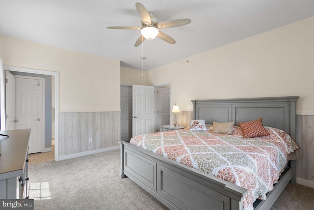 bedroom featuring baseboards, ceiling fan, light carpet, and a closet