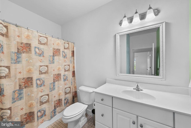 bathroom with toilet, tile patterned floors, curtained shower, and vanity