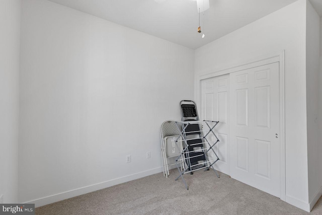 misc room featuring baseboards and carpet