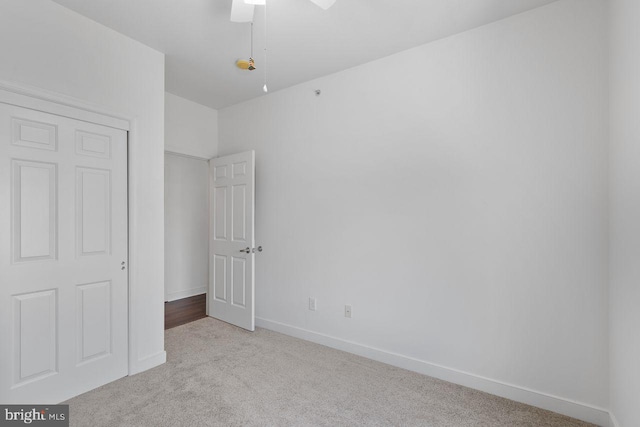 unfurnished bedroom featuring carpet floors, baseboards, and ceiling fan