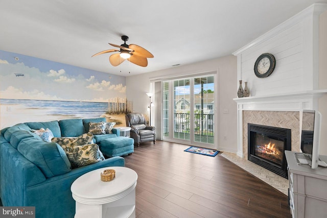 living room with ceiling fan, dark wood-style floors, and a premium fireplace