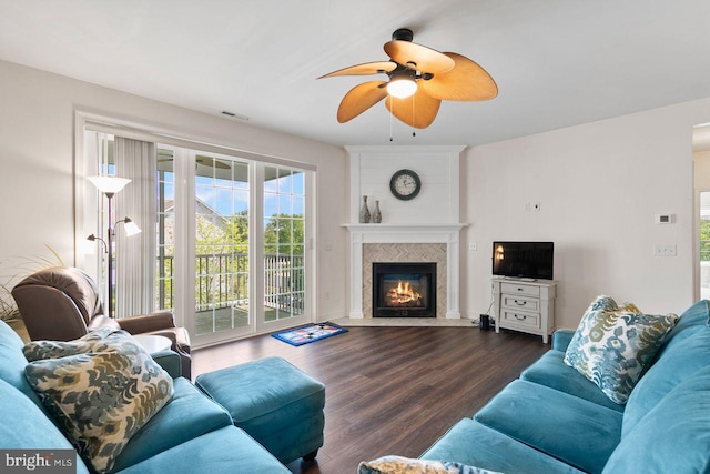 living room featuring ceiling fan, visible vents, a healthy amount of sunlight, and wood finished floors