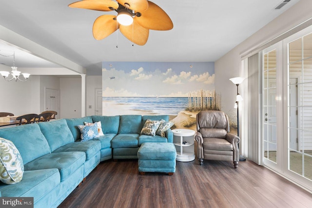 living room with ceiling fan with notable chandelier, wood finished floors, and visible vents