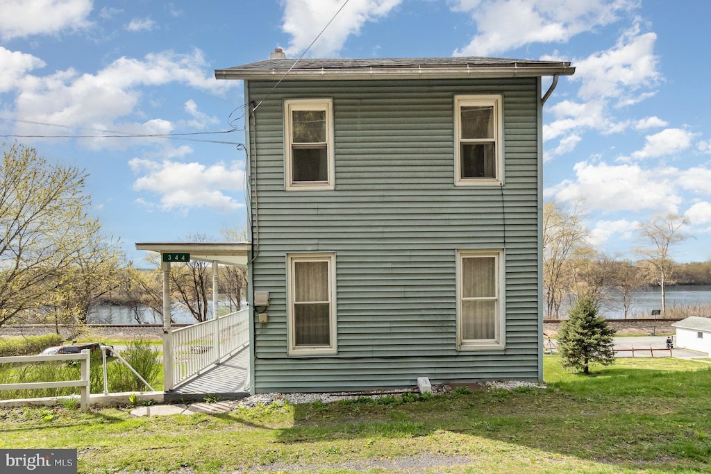 344 S Main St, Herndon, PA 17830 - rear view of house featuring fence, a yard, and a water view