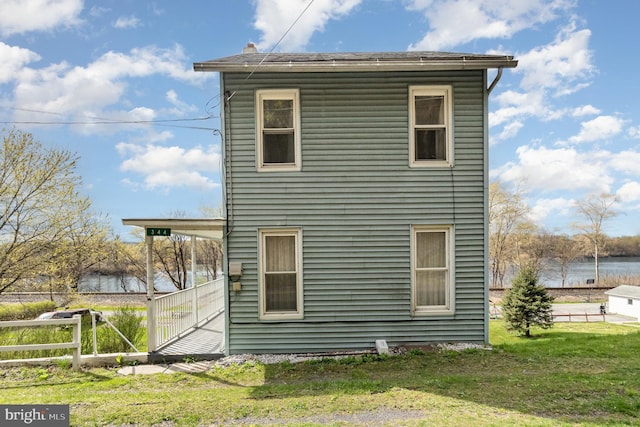 344 S Main St, Herndon, PA 17830 - rear view of house featuring fence, a yard, and a water view