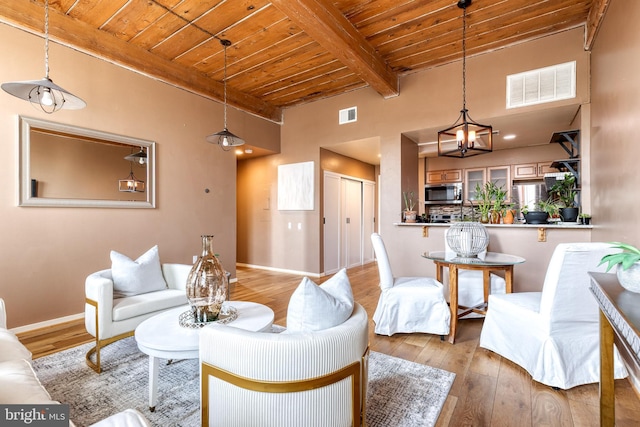2639 Boston St Unit 203, Baltimore, MD 21224 - living area with beam ceiling, visible vents, light wood-style floors, and wooden ceiling