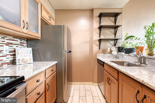 2639 Boston St Unit 203, Baltimore, MD 21224 - kitchen featuring open shelves, glass insert cabinets, a sink, stainless steel appliances, and light stone countertops