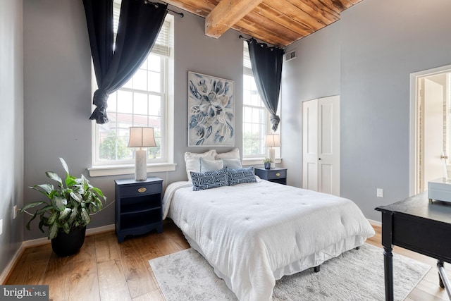 2639 Boston St Unit 203, Baltimore, MD 21224 - bedroom with multiple windows, beam ceiling, wood finished floors, and wood ceiling