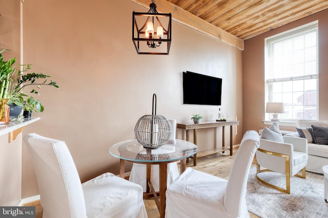2639 Boston St Unit 203, Baltimore, MD 21224 - living room featuring baseboards, wood finished floors, a chandelier, and wood ceiling