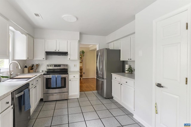 1720 Franklin Dr, Charlottesville, VA 22911 - kitchen with light countertops, appliances with stainless steel finishes, white cabinetry, and a sink