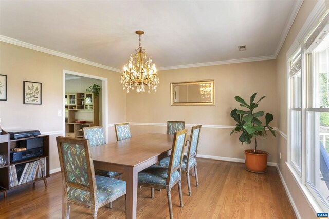 1720 Franklin Dr, Charlottesville, VA 22911 - dining area with crown molding, wood finished floors, an inviting chandelier, baseboards, and visible vents