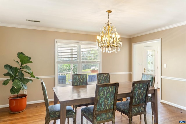 1720 Franklin Dr, Charlottesville, VA 22911 - dining space featuring visible vents, an inviting chandelier, light wood-style floors, and crown molding