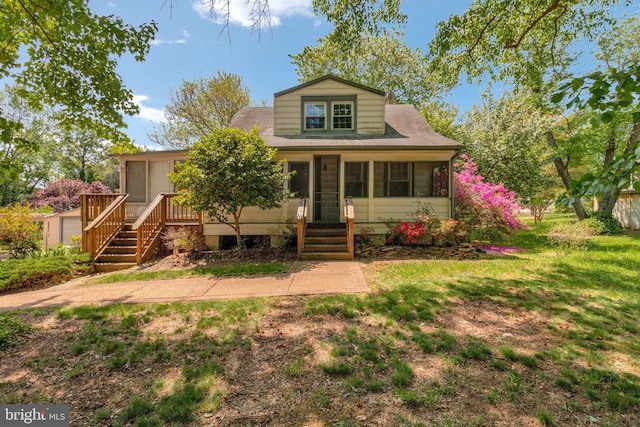 6230 Valley View Dr, Alexandria, VA 22310 - view of front of home with a sunroom, a front lawn, and stairway