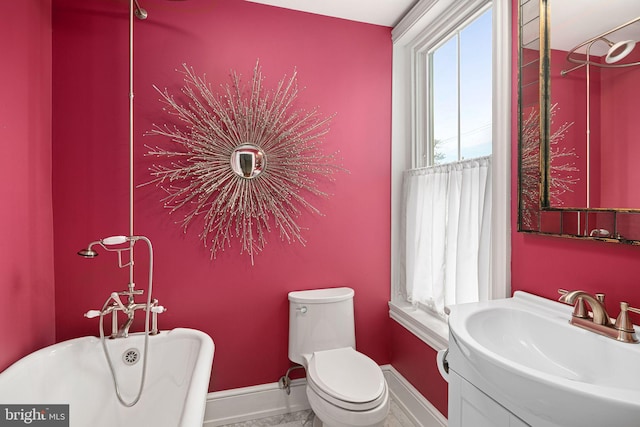 20-22 W Harvey St, Philadelphia, PA 19144 - bathroom featuring a freestanding tub, marble look tiles, baseboards, toilet, and vanity