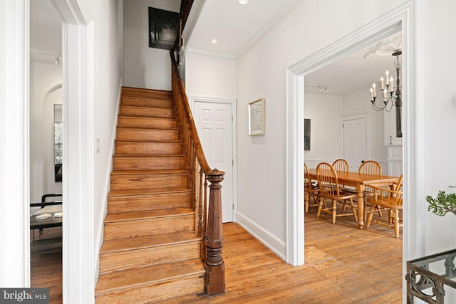 20-22 W Harvey St, Philadelphia, PA 19144 - stairway with wood finished floors, a chandelier, ornamental molding, baseboards, and recessed lighting