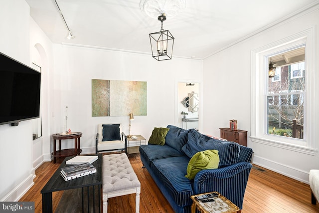 20-22 W Harvey St, Philadelphia, PA 19144 - living room featuring wood finished floors, baseboards, a chandelier, crown molding, and arched walkways