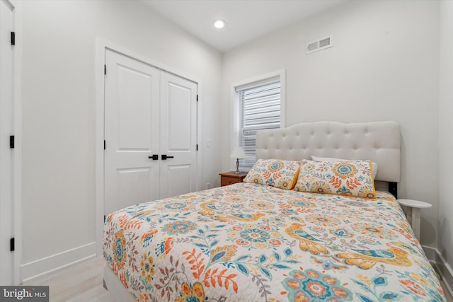 bedroom with baseboards, a closet, and recessed lighting