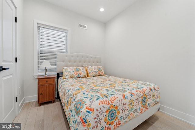 bedroom featuring wood finished floors, baseboards, and recessed lighting