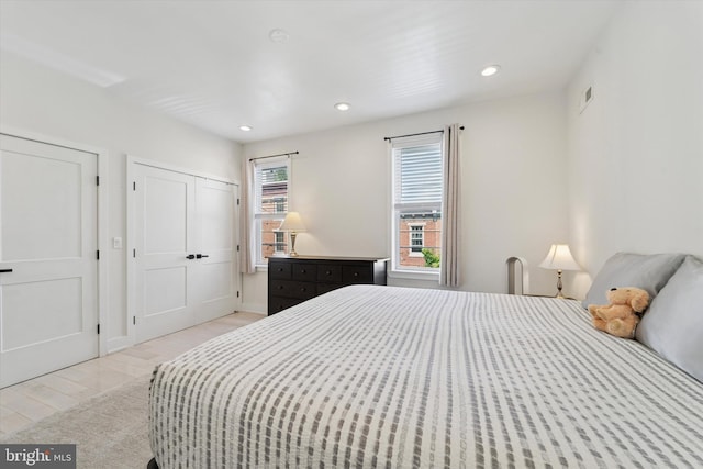 bedroom featuring light wood-style flooring and recessed lighting
