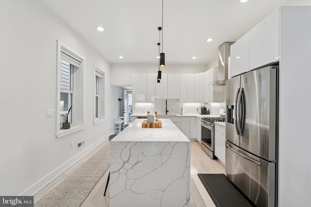 kitchen with appliances with stainless steel finishes, modern cabinets, white cabinetry, and recessed lighting