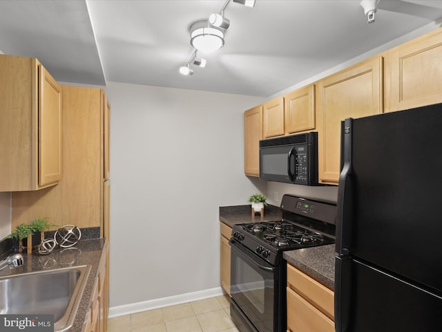 350 G St SW Unit N407, Washington, DC 20024 - kitchen featuring dark countertops, light brown cabinets, light tile patterned floors, a sink, and black appliances