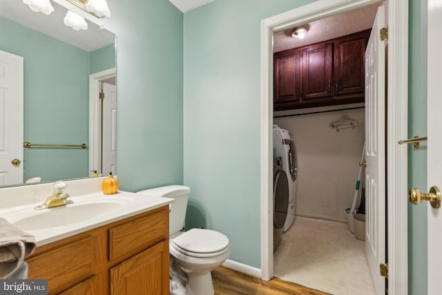 15915 Marlington Dr, Dumfries, VA 22025 - bathroom with washing machine and dryer, toilet, and vanity