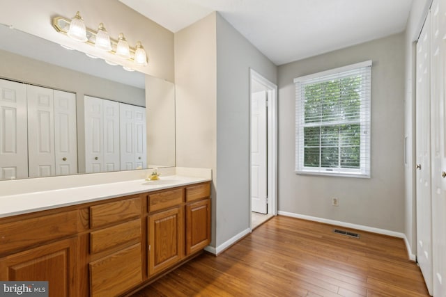 15915 Marlington Dr, Dumfries, VA 22025 - bathroom featuring wood finished floors, baseboards, and vanity