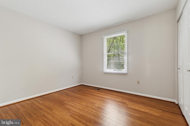 15915 Marlington Dr, Dumfries, VA 22025 - unfurnished bedroom with a closet, baseboards, and wood finished floors