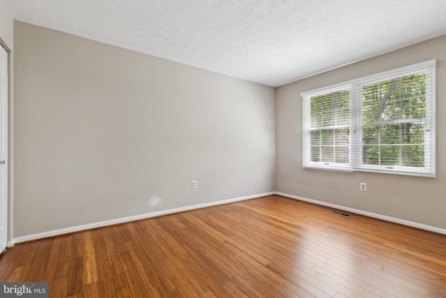 15915 Marlington Dr, Dumfries, VA 22025 - empty room featuring baseboards, wood finished floors, and a textured ceiling