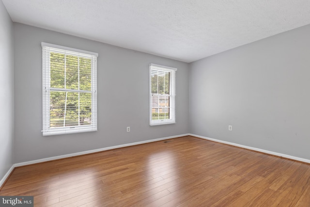 15915 Marlington Dr, Dumfries, VA 22025 - unfurnished room featuring baseboards, wood finished floors, and a textured ceiling