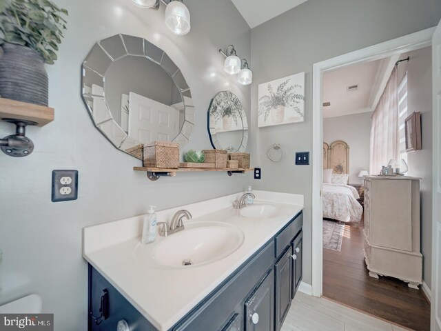 9477 Cromarty Ct, Bristow, VA 20136 - bathroom featuring a sink, ensuite bath, double vanity, and wood finished floors