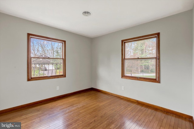 spare room with light wood-style flooring and baseboards