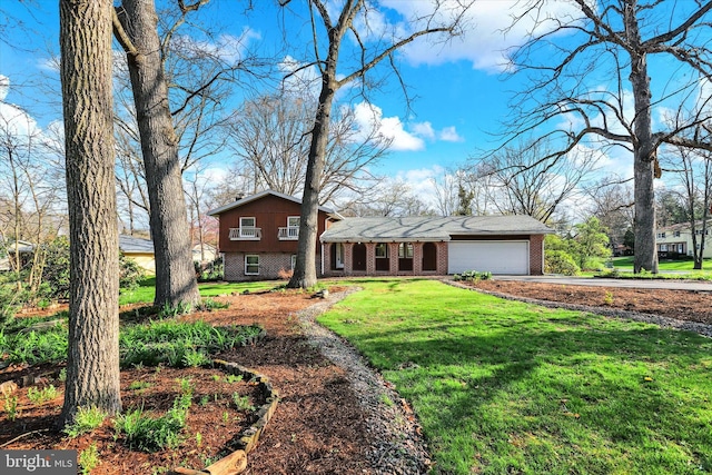 split level home featuring brick siding, an attached garage, a front yard, and concrete driveway