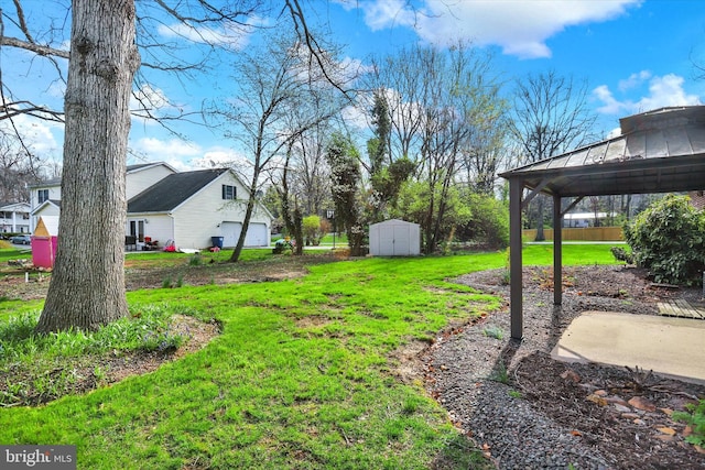 view of yard featuring a gazebo, an outbuilding, and a storage unit