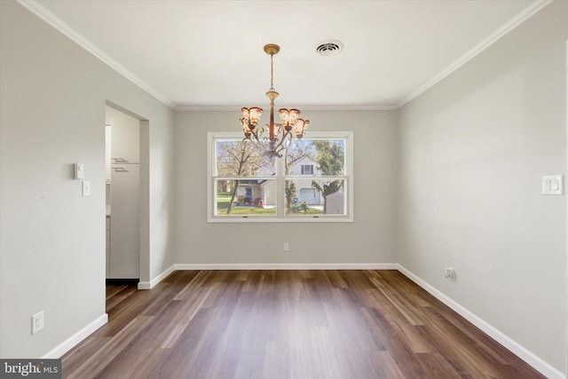 unfurnished dining area with baseboards, dark wood-style floors, ornamental molding, and an inviting chandelier