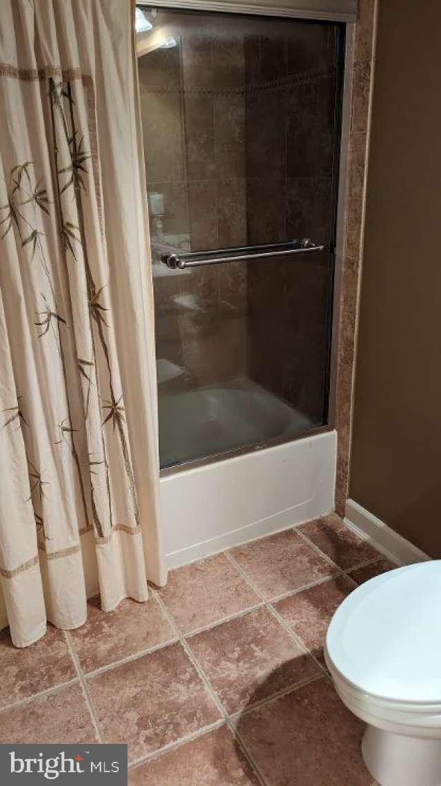 402 Village Center Blvd, Milton, DE 19968 - full bath featuring tile patterned flooring, toilet, baseboards, and shower / bath combo