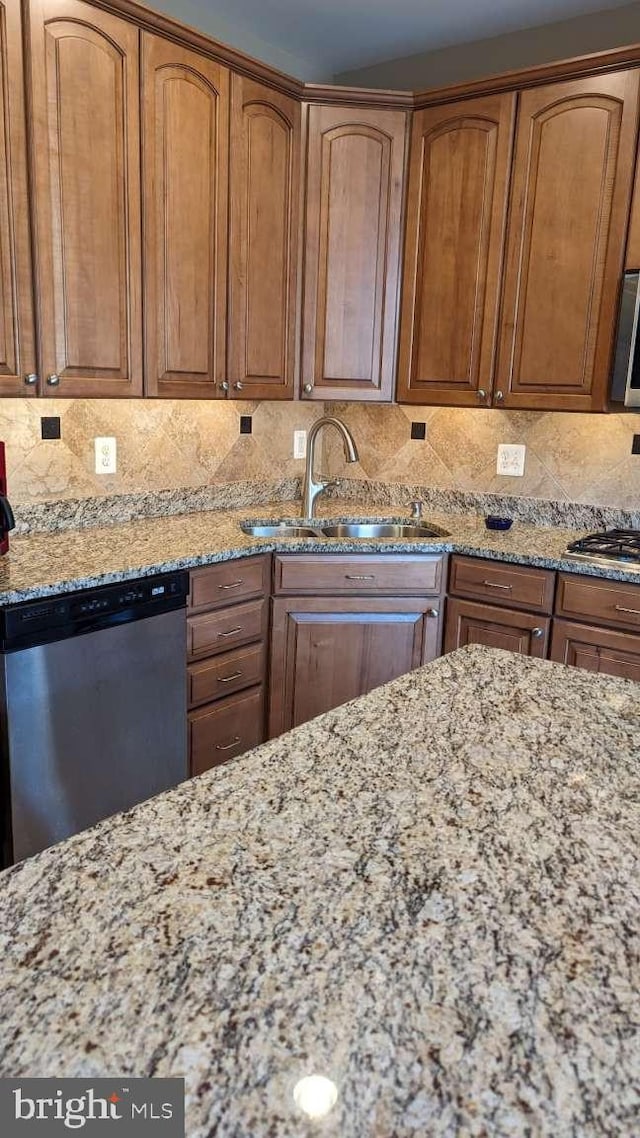 402 Village Center Blvd, Milton, DE 19968 - kitchen with appliances with stainless steel finishes, decorative backsplash, light stone counters, and a sink