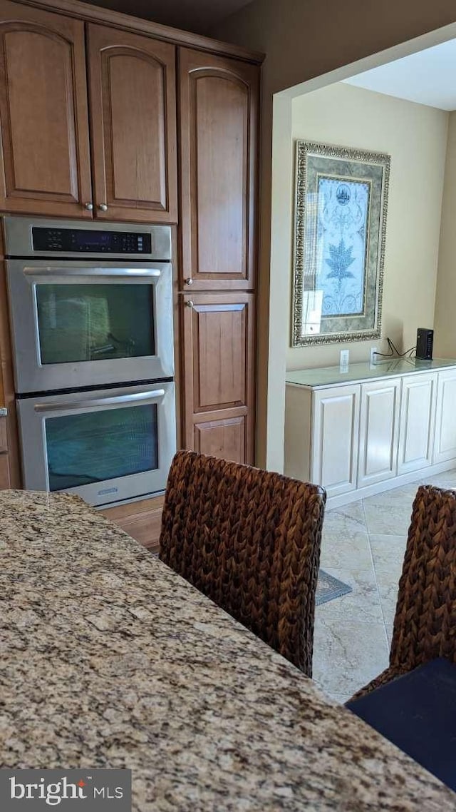 402 Village Center Blvd, Milton, DE 19968 - kitchen featuring light stone counters and double oven