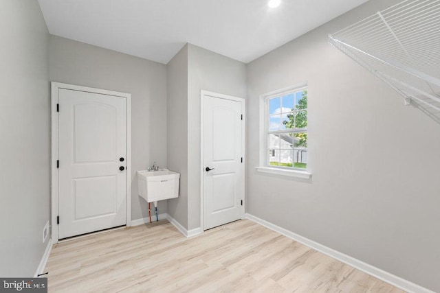 unfurnished bedroom featuring wood finished floors and baseboards