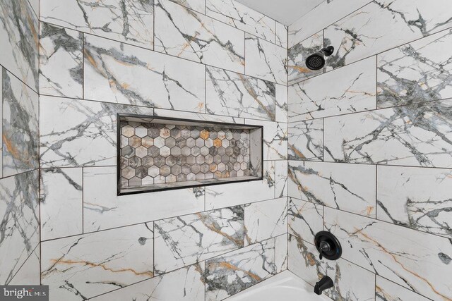 bathroom view of shower / bathtub combination
