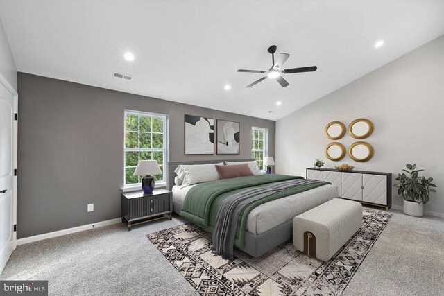 bedroom with multiple windows, light carpet, vaulted ceiling, baseboards, and recessed lighting